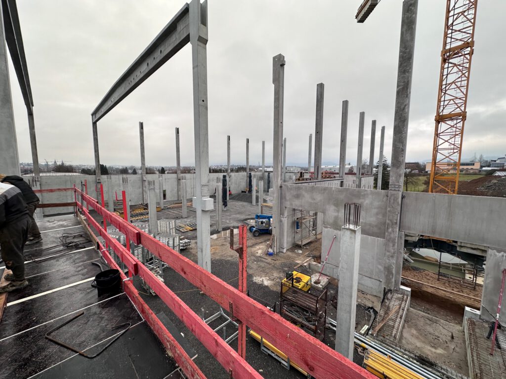 Hallenrohbau mit Betonfertigteilstützen und Turmdrehkran der Lagerhalle in Öhringen